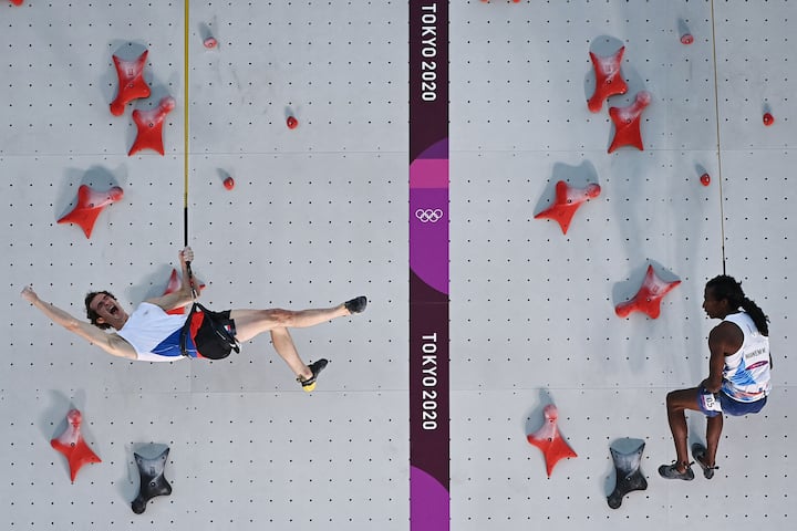 TOPSHOT - Czech Republic's Adam Ondra (L) celebrates beating France's Mickael Mawem in their men's sport climbing speed finals during the Tokyo 2020 Olympic Games at the Aomi Urban Sports Park in Tokyo on August 6, 2021. (Photo by MOHD RASFAN / AFP)